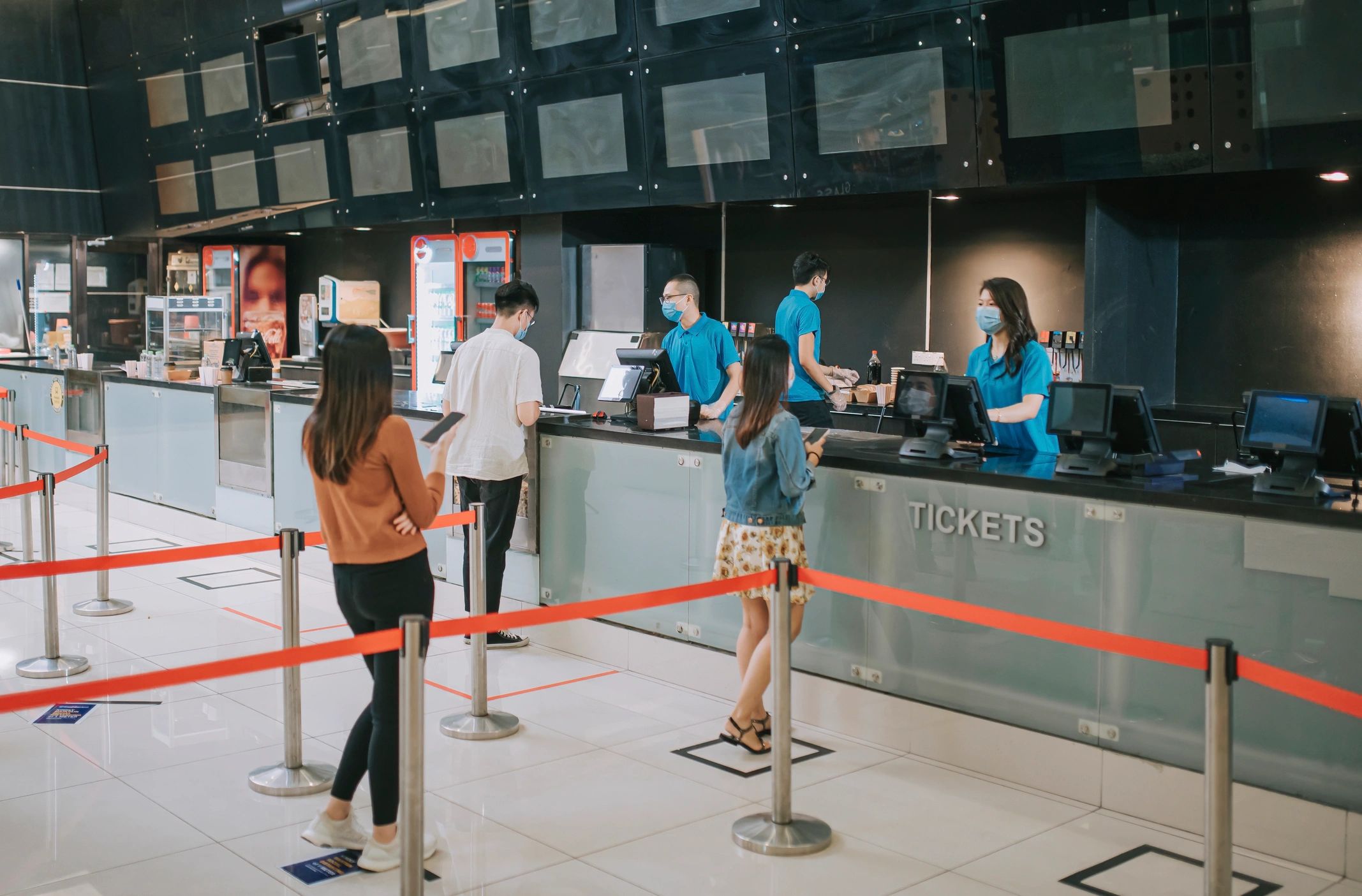 Moviegoers at a cinema ticket counter