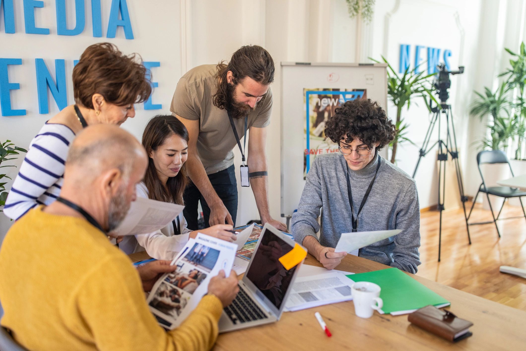 Magazine editors collaborating in a modern editorial office