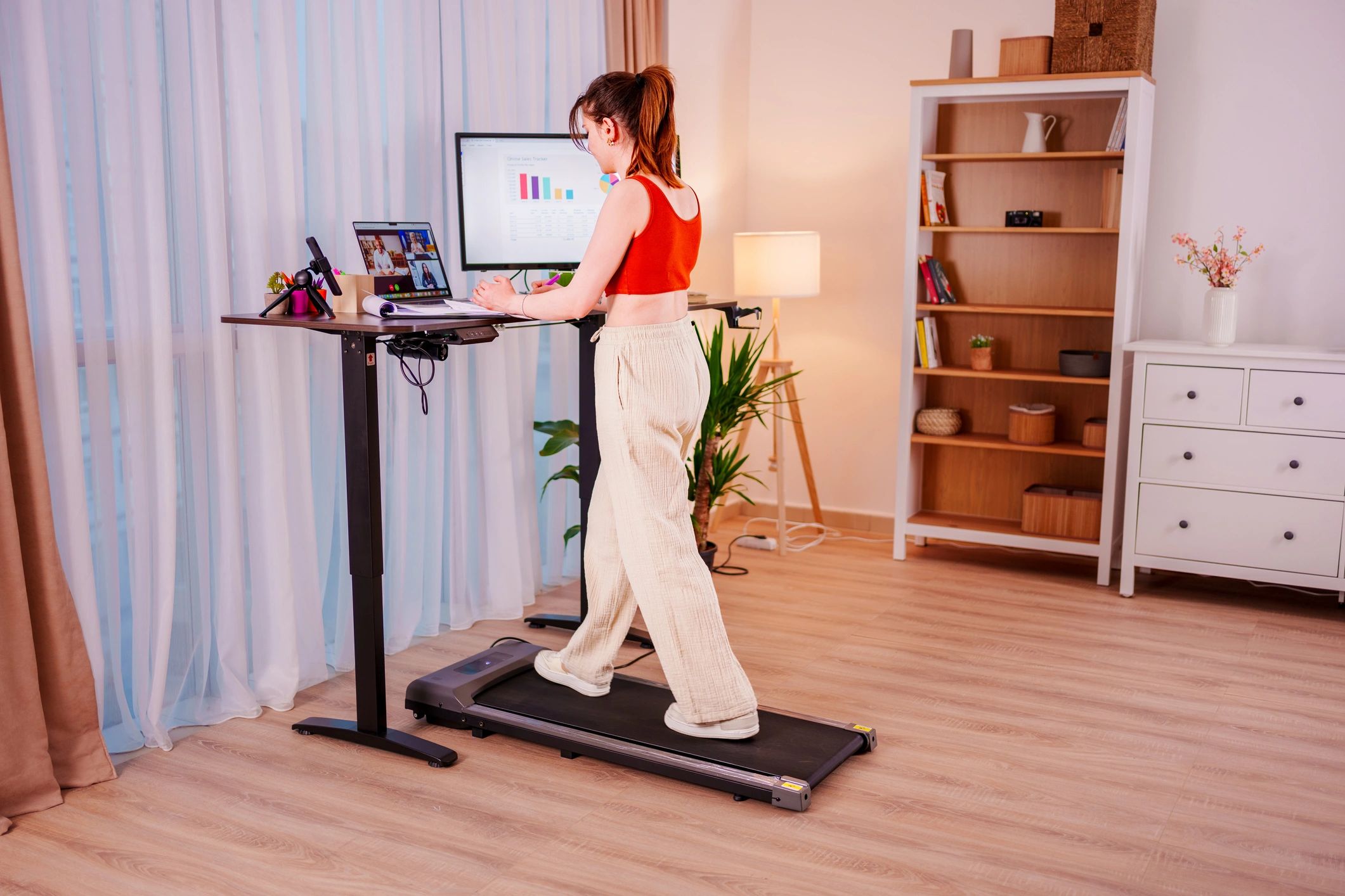 Professional reviewing market charts at a standing desk