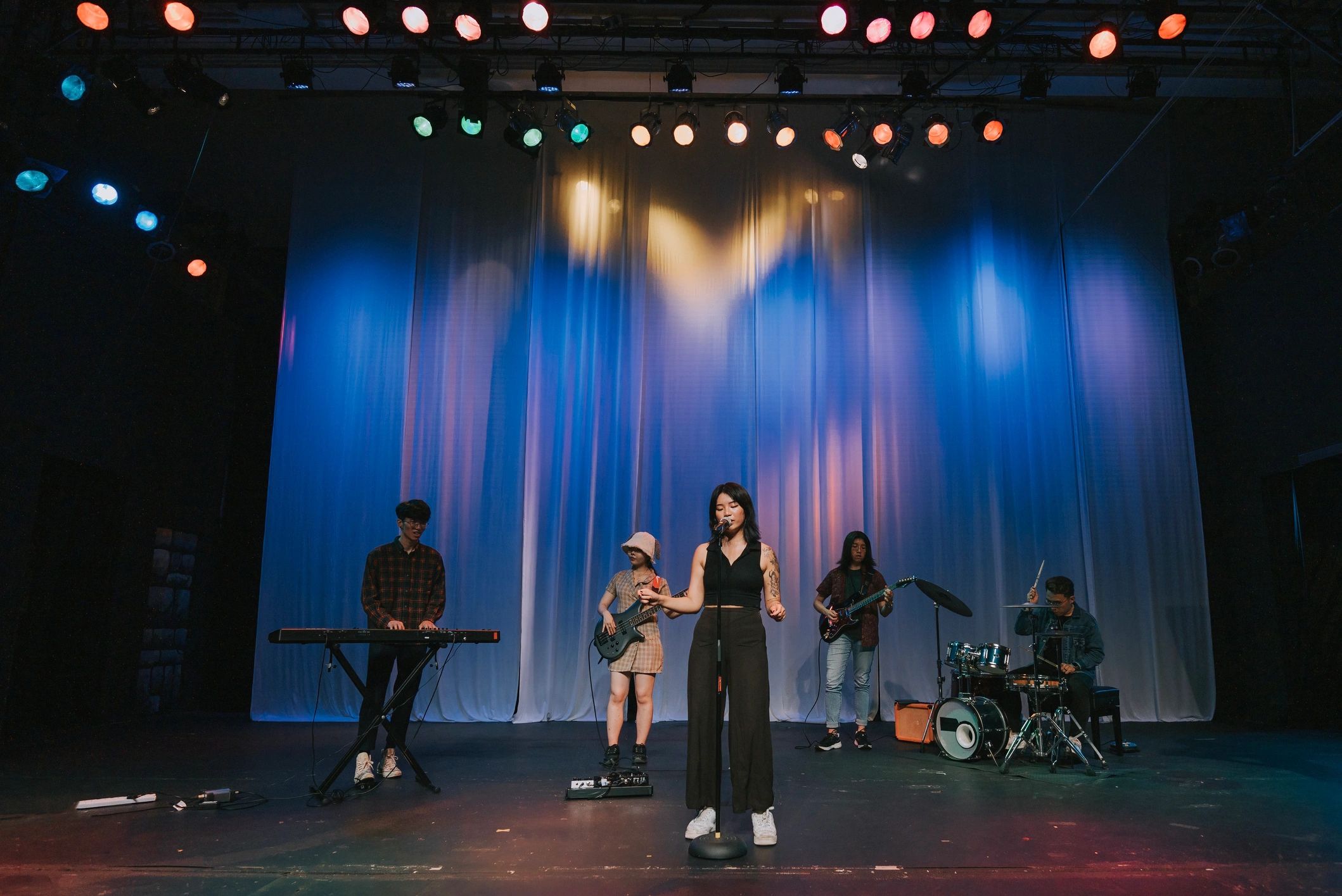 Live band performing under concert stage lights