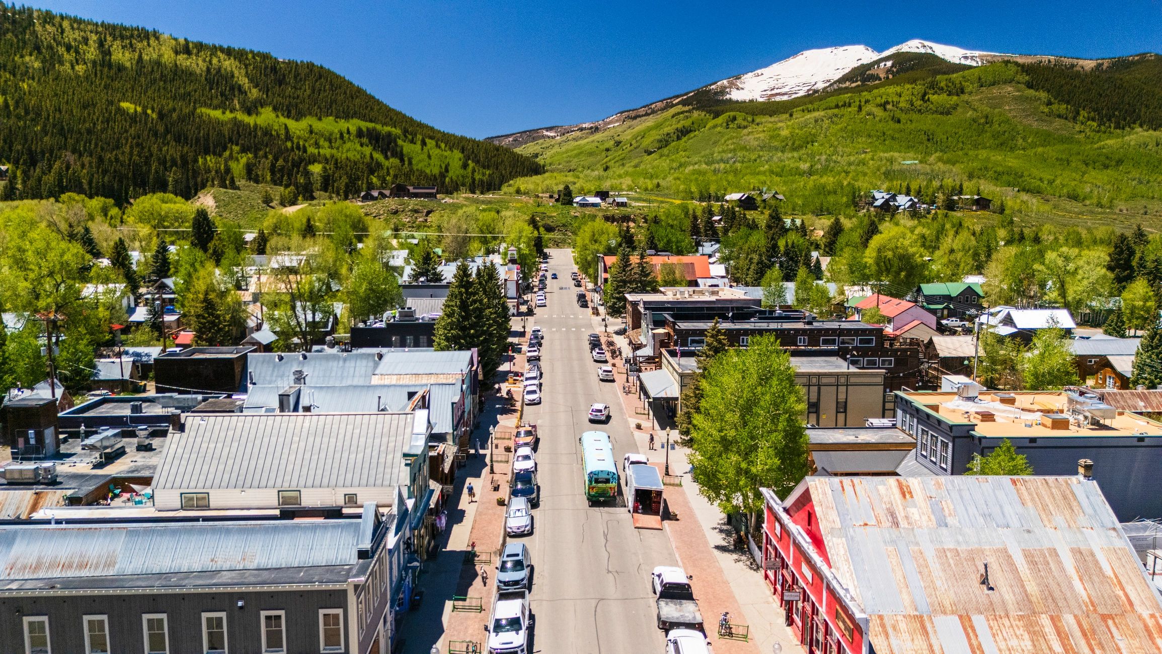 Green mountain town surrounded by forested hills